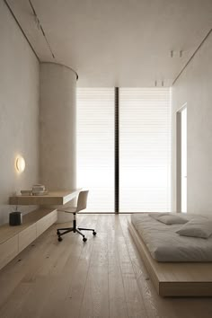 an empty room with a bed, desk and chair in it's center area