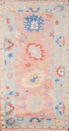 an old rug with many different colors and patterns on the carpet, including blue, pink,