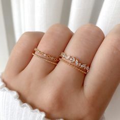 This lovely ring centers on an eye-catching round crystal, finished with marquise crystals and a beaded pattern band. Type: Adjustable ring (approx. size 6) Main material: Rose Gold, Rhodium, 16k Gold Plated on Brass,  Cubic Zirconia Need some jewelry inspiration? Follow us on Instagram  @statementGrey Rose Gold Rings With Rhinestones For Gift, Rose Gold Rhinestone Ring Gift, Rose Gold Rhinestone Rings For Gift, Crystal Promise Ring With Rhinestones, Dainty Jewelry With Sparkling Stones For Promise Ring, Fine Jewelry Wedding Ring With Rhinestones, Dainty Sparkling Gold Ring, Dainty Sparkling Wedding Rings, Wedding Chain Ring With Cubic Zirconia