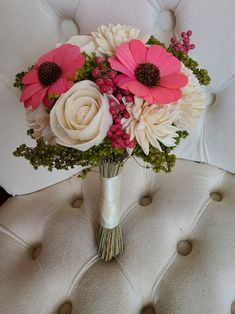 a bouquet of flowers sitting on top of a white chair