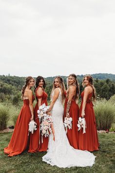 the bride and her bridesmaids are all wearing red dresses