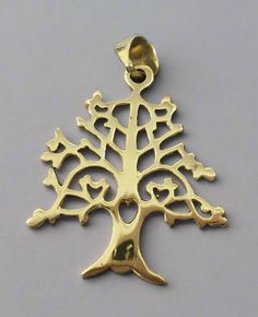 Tree of life pendant made out of brass in India. Makes a beautiful gift. Size of pendant: 1.5" by 1.25". A Tree of Life brass pendant is a meaningful piece of jewelry, often symbolizing growth, strength, and interconnectedness. The design typically features a tree with sprawling branches and deep roots, representing the connection between the earth and the sky, as well as personal development through life’s experiences. Made from brass, the pendant has a warm, golden hue that gives it a rustic a Tree Of Life Stone Carving, Tree Of Life Large Pin, Elegant Yellow Gold Tree Of Life Necklace, Wooden Tree Of Life Pendant, Bohemian Tree Of Life Pendant Jewelry, Tree Of Life Pendant Gold, Yellow Gold Sterling Silver Tree Of Life Necklace, Tree Of Life Pendant Black, Silver Tree Of Life Pendant