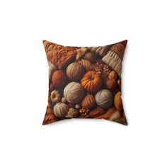 a pillow with shells and pumpkins on it