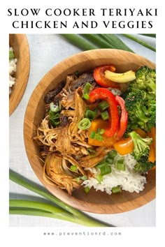 a wooden bowl filled with chicken and veggies