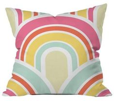 a pillow with an abstract rainbow design on it