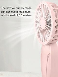 a pink fan sitting on top of a table next to a white wall with text that reads the new air supply model can achieve maximum wind speed of 6 5 meters