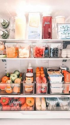 an open refrigerator filled with lots of different types of fruit and juice in plastic containers