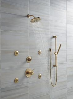 the shower head and handset are connected to the wall in this modern style bathroom