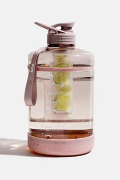 a glass jar filled with sliced lemons on top of a table