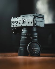 a camera sitting on top of a wooden table