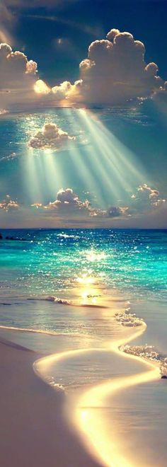 the sun shines through clouds over an ocean beach with white sand and blue water