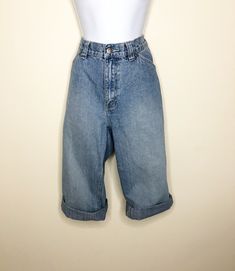 This is a pair of capri/cropped Lee Riveted jeans. They are high rise with all the fun details of carpenter jeans. Loops and pockets and wide belt loops add interest. Faded medium blue wash. Size 10 M. Check measurements carefully. Measurements taken with jeans laying flat and doubled where appropriate. In order to determine fit we recommend comparing measurements with an item that fits you well. Length 29 inches Waist 32 inches Hips 40 inches Inseam 19 inches Rise 10 inches Always happy to answ Cropped Rigid Denim Jeans With Belt Loops, Rigid Denim Cropped Jeans With Belt Loops, Retro Spring Cargo Jeans In Denim, Medium Wash Wide Leg Cropped Jeans With Belt Loops, Vintage Denim Blue Cargo Jeans For Spring, Vintage Cargo Jeans In Denim Blue For Spring, Trendy High Waist Denim Capris, Spring Cropped Capri Length Denim Jeans, Spring Retro Cropped Denim Jeans