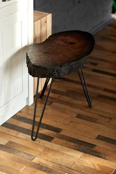 a wooden bench sitting on top of a hard wood floor