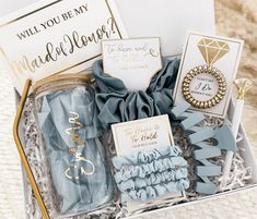 a gift box filled with blue and gold items for someone's special occasion or birthday