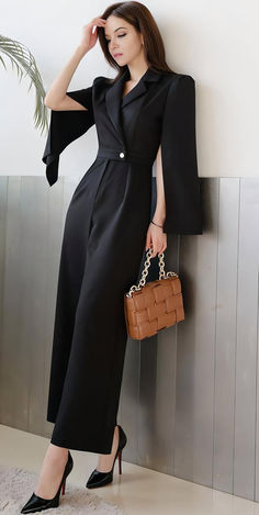 Discover our stylish and elegant black jumpsuit, perfect for formal events, business meetings, or a chic night out. This versatile piece features a belted waist, wide-leg trousers, and unique cape-style sleeves. Made from high-quality fabric, it ensures comfort and durability. Elevate your wardrobe with this timeless and sophisticated outfit idea. Perfect for those seeking outfit inspiration, fashion ideas, and stylish looks. Solid Color Jumpsuits And Rompers For Evening In Fall, Elegant Solid Color Jumpsuits And Rompers For Fall, Elegant Solid Color Fall Jumpsuits And Rompers, Elegant Evening Jumpsuits And Rompers For Fall, Elegant Jumpsuits And Rompers For Evening In Fall, Elegant Fall Jumpsuits And Rompers In Solid Color, Chic Evening Jumpsuits And Rompers For Fall, Black Formal Jumpsuits And Rompers For Fall, Chic Office Jumpsuits For Fall