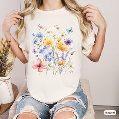 Discover our beautiful shirt with a colorful floral design adorned with butterflies and a dragonfly. This unique shirt is perfect for spring or summer and is guaranteed to turn heads.  Still looking for a special gift for Mother's Day? This shirt is ideal for moms who love flowers or enjoy gardening. Show your mother your appreciation with this loving and stylish gift.  ♥ PRODUCTION TIME: 1-5 days (Usually 2-3 days)   ♥ SHIPPING TIME: 2-5 days (Usually 3 days)   ♥ PRODUCT DESCRIPTION: Bella Canv Summer Cotton Shirt With Butterfly Print, Multicolor Floral Print T-shirt For Summer, Multicolor Butterfly Print Top For Summer, Multicolor Butterfly Print Tops For Summer, Spring Floral Print Multicolor Shirt, Spring Multicolor Print Cotton T-shirt, Spring Multicolor Cotton T-shirt, Casual Multicolor Print Shirt For Spring, Spring Botanical Shirt With Floral Print