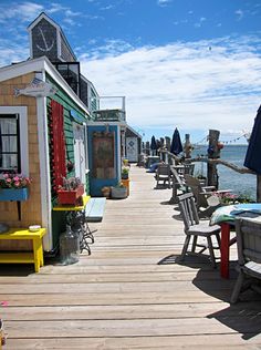 there are many tables and chairs on the dock