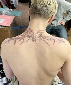 a man with a tattoo on his back