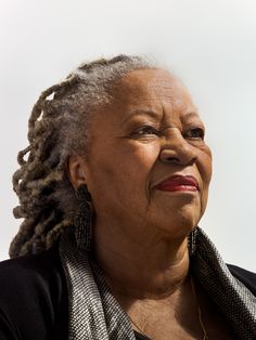 an older woman with dreadlocks looking off into the distance