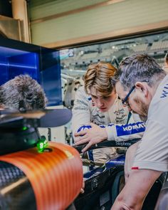 three people looking at something on a computer screen