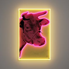 a neon sign with a cow's head in the center, on a gray background