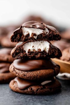 chocolate ice cream sandwich cookies stacked on top of each other with one cookie in the middle