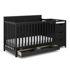 a black crib with two drawers and an open drawer in the bottom half, on a white background