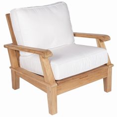 a wooden chair with white cushions on it's back legs and arms, against a white background