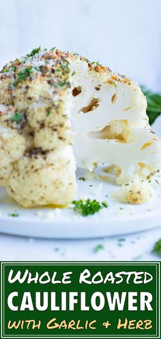 cauliflower with garlic and herbs on a plate next to the words whole roasted cauliflower