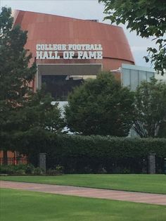 the college football hall of fame sign is in front of some trees