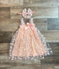 Our Beautiful Peach Sun Dress with Daisy Mesh Overlay is the perfect dress for baby girl to wear for her 1/2 Birthday , First Birthday or just for fun.  Dress would make a perfect gift for any baby girl or mommy expecting a baby girl. Dress is made with a soft peach cotton - Elastic straps and a beautiful Peach Daisy Print Overlay - Big Thick Peach Bow is attached to a soft and stretchy headband. Bow can also be made on a clip if headband is not needed. (you can choose that option at check out ) Sizes available - 6-12 months 12-24 months  3t-4t  *PROCESSING TIME: We ship 1-2 business days. You can see the exact shipping dates in your receipt. Please convo us if you need for specific date and leave your date needed by at check out in the note to seller box.  *SHIPPING: Regular First Class Groovy One, Dress For Baby Girl, Expecting A Baby, Headband Bow, Baby Girls Dresses, First Birthday Outfit, Dress For Baby, Daisy Dress, Stretchy Headbands