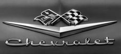 the chevrolet logo is shown in this black and white photo, with checkered flags on it