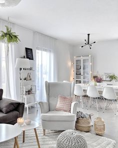 a living room filled with furniture and white walls