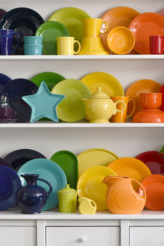 the shelves are full of colorful dishes and cups, including one with a star on it