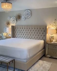 a bedroom with a bed, dressers and lamps in it's center area