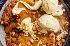 a skillet filled with ice cream and caramel toppings on top of it