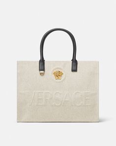 La Medusa Canvas Large Tote Bag Beige | Versace US Luxury Double Handle Shoulder Bag With Engraved Logo, Luxury Shoulder Bag With Engraved Logo And Double Handle, Top Handle Shoulder Bag With Engraved Logo, Luxury Bags With Engraved Logo For Shopping, Luxury Shopping Bags With Engraved Logo, Beige Leather Bags With Logo Hardware, Elegant Double Handle Bag With Embroidered Logo, Luxury Double Handle Canvas Bag For Shopping, Luxury Beige Shoulder Bag With Logo Hardware