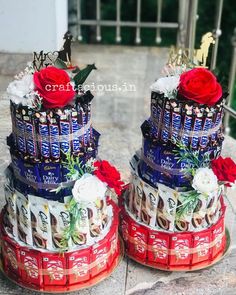 two cakes made to look like they are stacked on top of each other with chocolate bars and roses