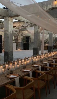 a long table with many lit candles on it