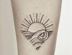 a tattoo on the leg of a person with an eye and sun in it's center