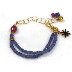 Glittering, vibrantly hued genuine polished natural periwinkle hued tanzanite, one of the rarest and most prized of all gemstones, sparkles on this strand in a beautiful bright striking splash of color! A plump faceted pink sapphire accents the side of the wrist. 14k gold fill chain and colorful drop embellishments add a little chic bling. l Blue Faceted Amethyst Jewelry, Faceted Blue Amethyst Jewelry, Tanzanite Gemstone Bracelet Jewelry, Blue Tanzanite Bracelet Jewelry, Handmade Tanzanite Blue Jewelry, Blue Amethyst Bracelets With Natural Stones, Fine Jewelry Tanzanite Bracelets For Gift, Fine Jewelry Blue Amethyst Jewelry, Fine Jewelry In Blue Amethyst