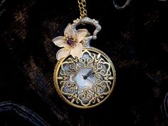 "A beautiful Art Nouveau pendant necklace watch with a handmade white flower.  This Vintage Victorian pocket watch is a beautiful gift for women who love romantic jewelry, and is also a very special gift for bridesmaids, an heirloom to keep, for Christmas, New Year, Valentines Day, Birthday, Wedding, Easter... The romantic Vintage style pendant watch by ANNALEAS FINEST features a beautiful flower, with a frosted white lucite flower and was created with a Swarovski® crystal in purple and goldplat Flower Pocket, Watch Art, Pendant Watch, Christmas Gift For Women, Pocket Watch Necklace, Art Nouveau Pendant, Celtic Necklace, Romantic Jewellery, Pendant Watches