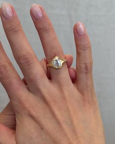 a woman's hand with a ring on it and a diamond in the middle