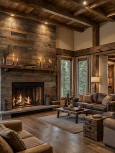 a living room filled with furniture and a fire place in the middle of a wooden floor