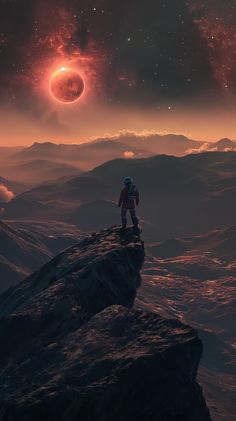 a man standing on top of a mountain next to a red and black object in the sky