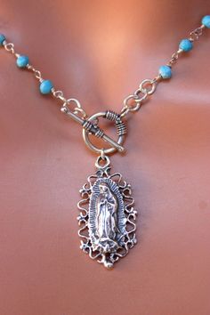 "This is a beautiful Our Lady of Guadalupe pendant choker necklace for women. Necklace features the toggle front with a 28x15mm Mother Mary pendant, 3-4mm faceted turquoise beads. This pendant choker necklace is 925 sterling silver. This necklace is even prettier in person! You may order it in other gemstone, see drop down list. Necklace may be ordered in a 15\" choker length shown, 16\", 18\", 20\" or 22\" length. Comes in a nice gift, example shown in last photo Also shown in pyrite and in gar Silver Our Lady Of Guadalupe Necklace, Spiritual Turquoise Necklace With Lobster Clasp, Catholic Jewelry Necklace, Lady Of Guadalupe Necklace, Virgin Guadalupe, Guadalupe Necklace, 14kt Gold Jewelry, Personalized Rosary, Rosary Jewelry