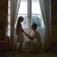 two women sitting in front of a window