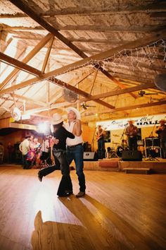 two people are dancing on the dance floor