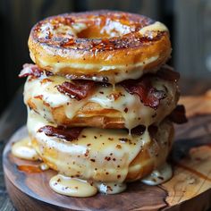 three donuts stacked on top of each other covered in bacon and glazes