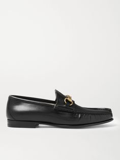 Gucci's iconic loafers were first introduced in 1953; it says a lot about the timelessness of the design that they've barely changed since. This glossy black version has been crafted in Italy from leather embellished with the hallmark horsebit that nods to the brand's equestrian heritage. Black Gucci Shoes, Loafers With Jeans, Leather Loafers For Men, Gucci Shoes Loafers, Loafers Gucci, How To Wear Loafers, Gucci Jeans, Mens Leather Loafers, Gucci T Shirt